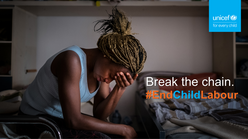 An adolescent girl sits and cries in a bedroom in a shelter. She was trafficked for sexual exploitation.