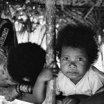 pmr_ashot_thumb_3 An orang asli child peers intently forward.