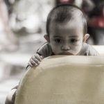 pmr_ashot_thumb_4 A sad looking child rests in chin on the bottom of a slide.